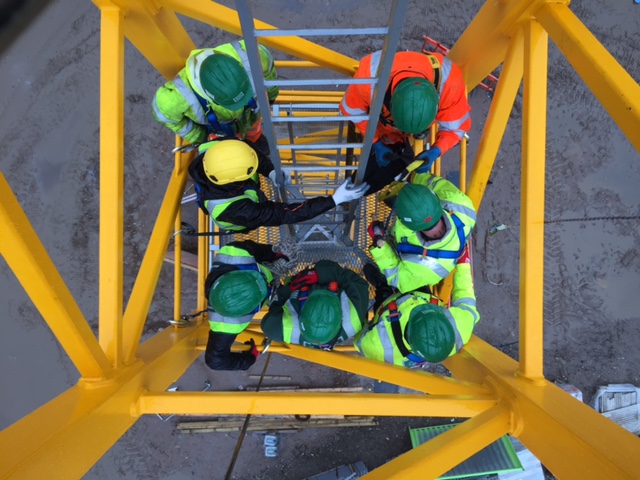 Image shows workers at height.