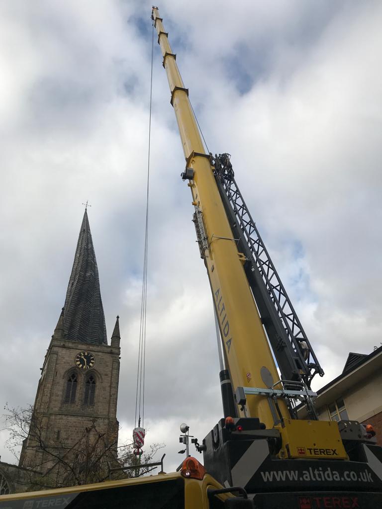 photo shows a crane and chesterfields crooked spire