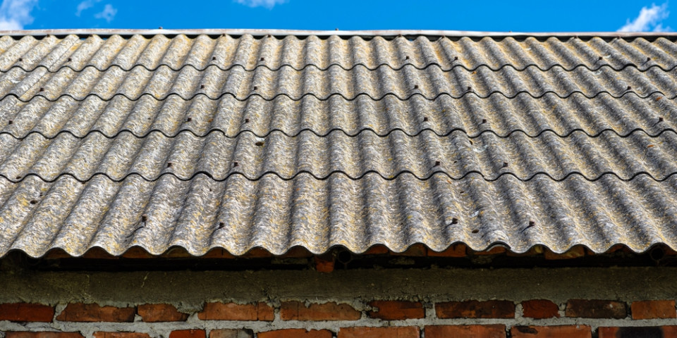 Corrugated cement roof sheets on an older building, a common location where asbestos may be present in pre-2000 properties.